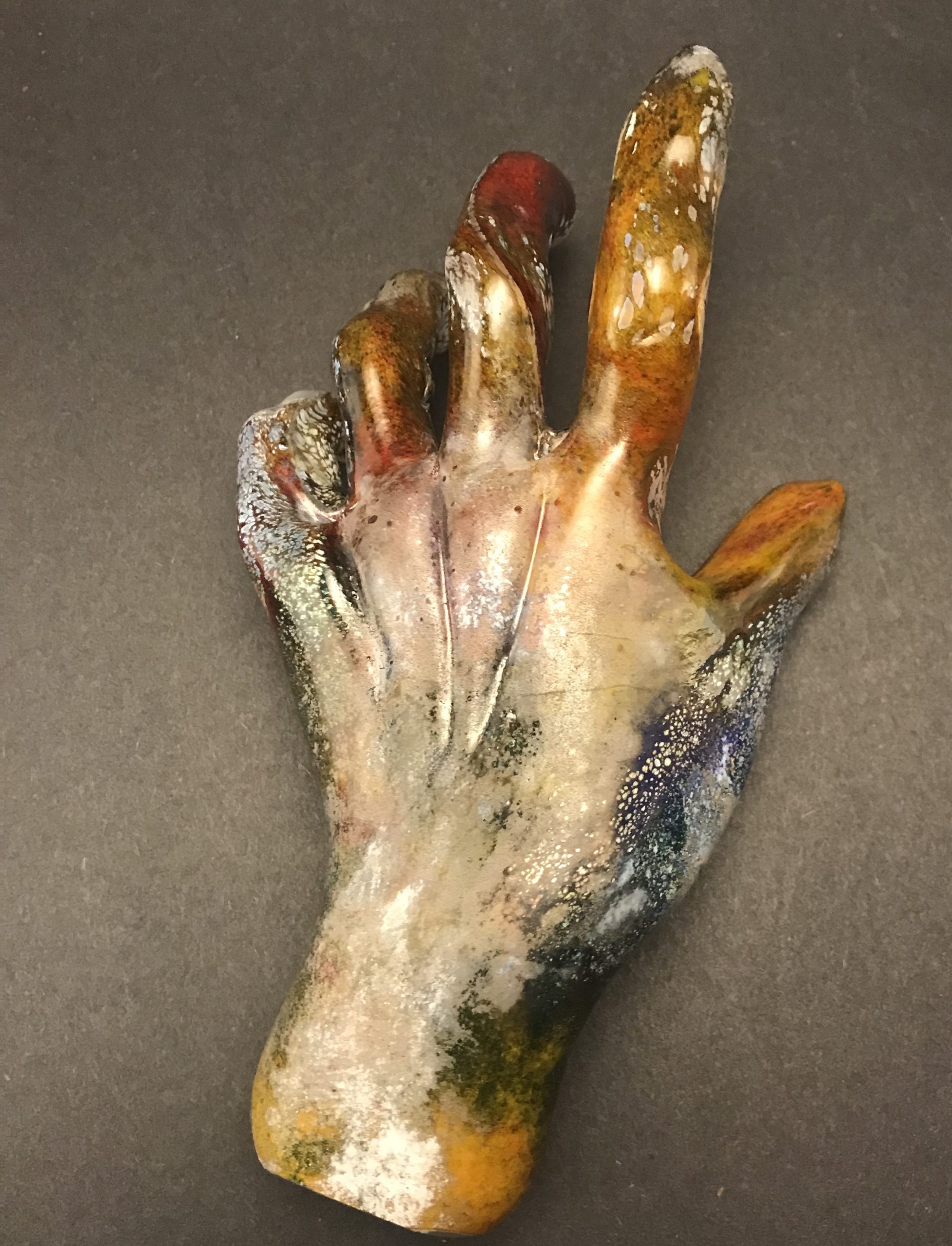 Glass sculpture of rainbow hand