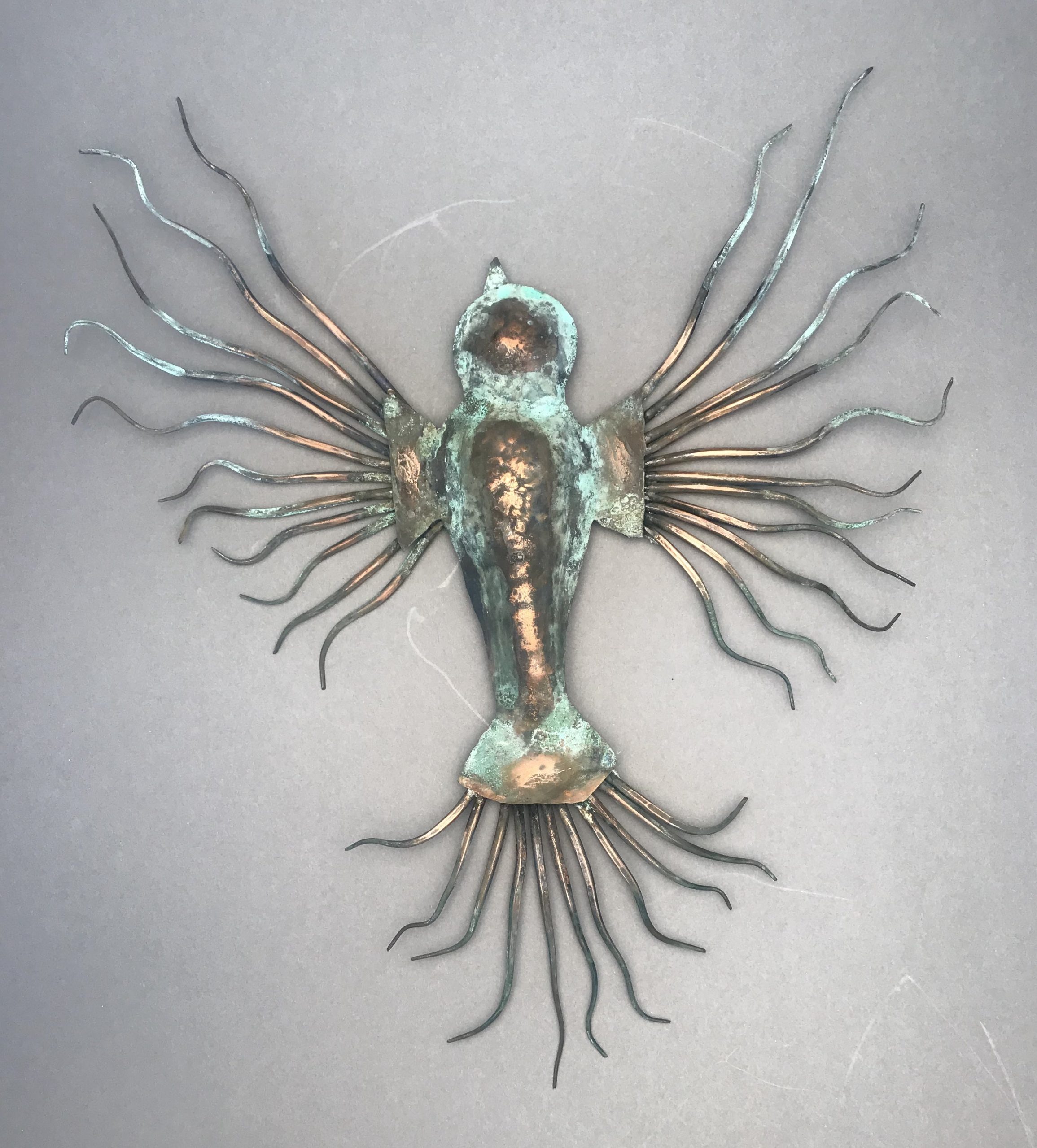 Metal sculpture of a fictional creature that combines sea slugs and birds