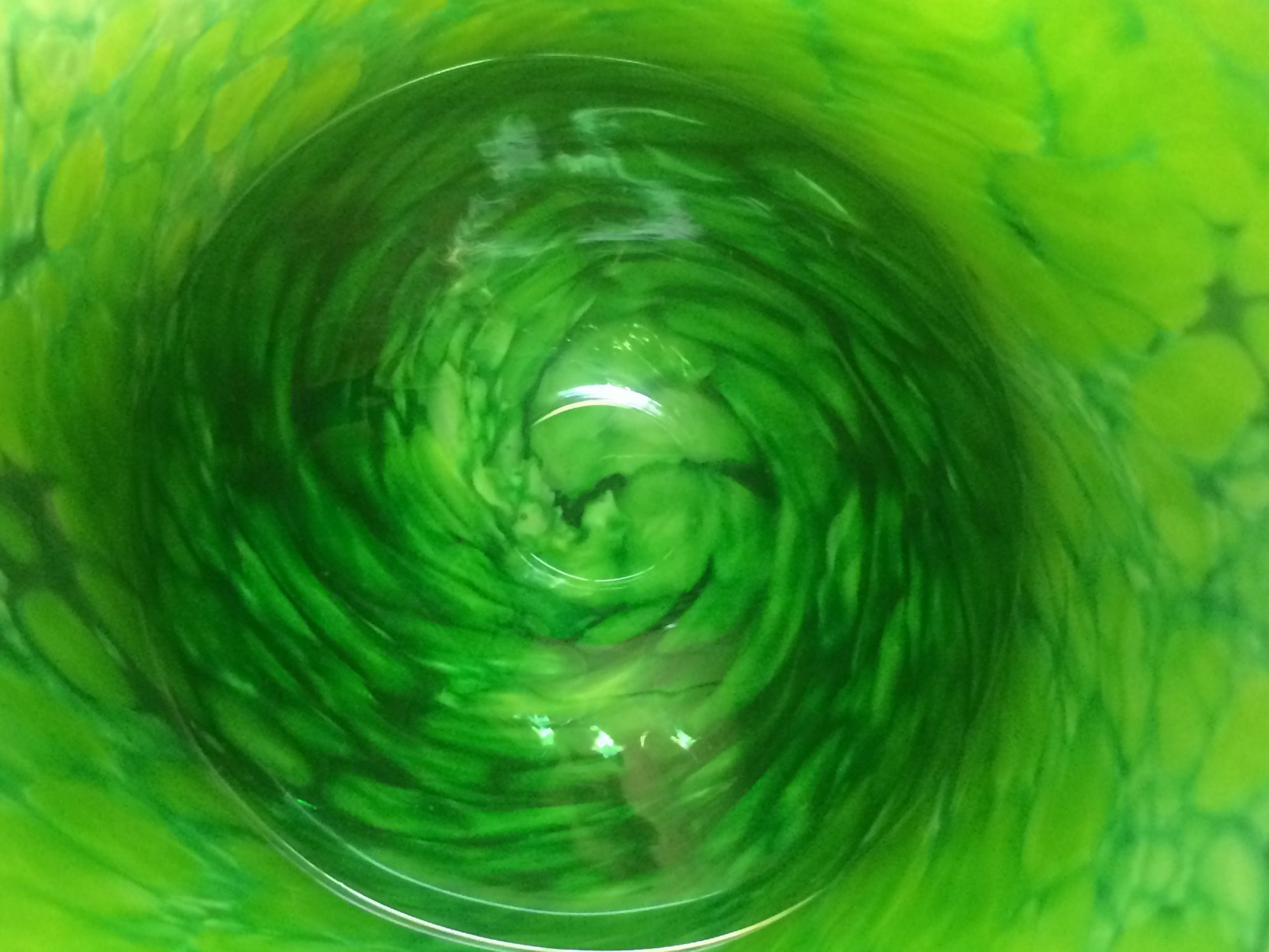 Lensed bottom of a green glass